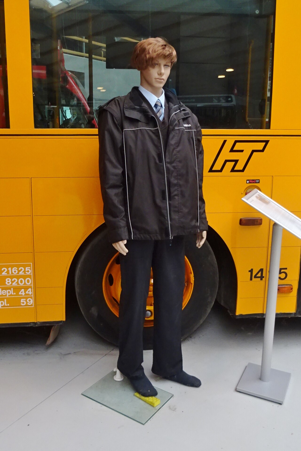 Chauffeur in uniform holding arrival sign